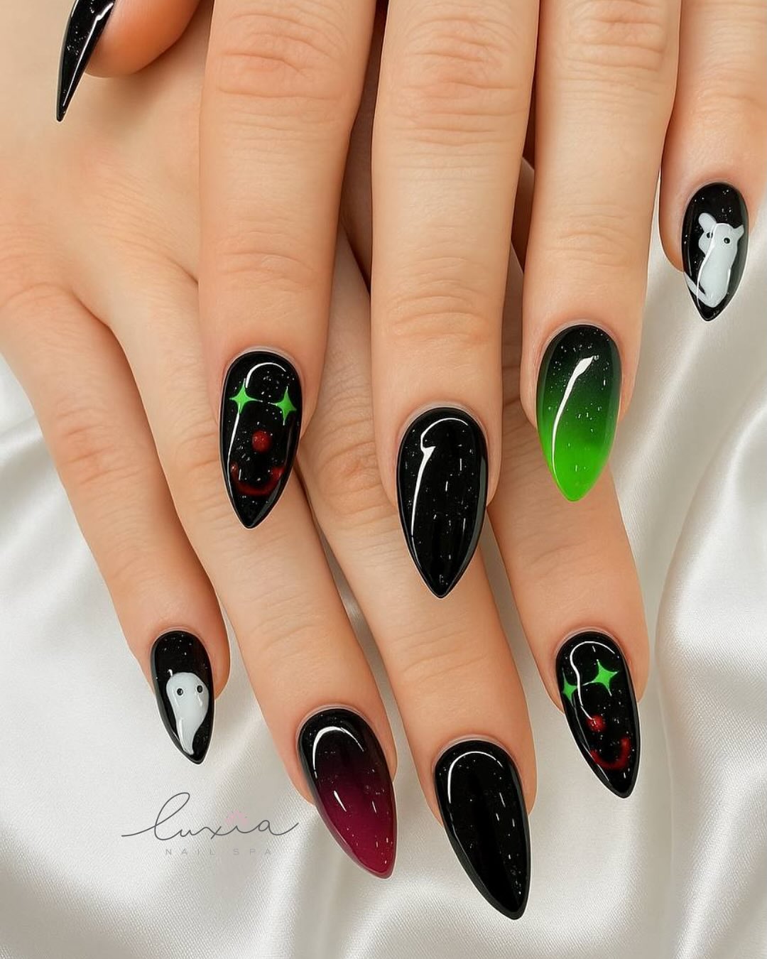 Halloween themed stiletto nails with ghost and galaxy art