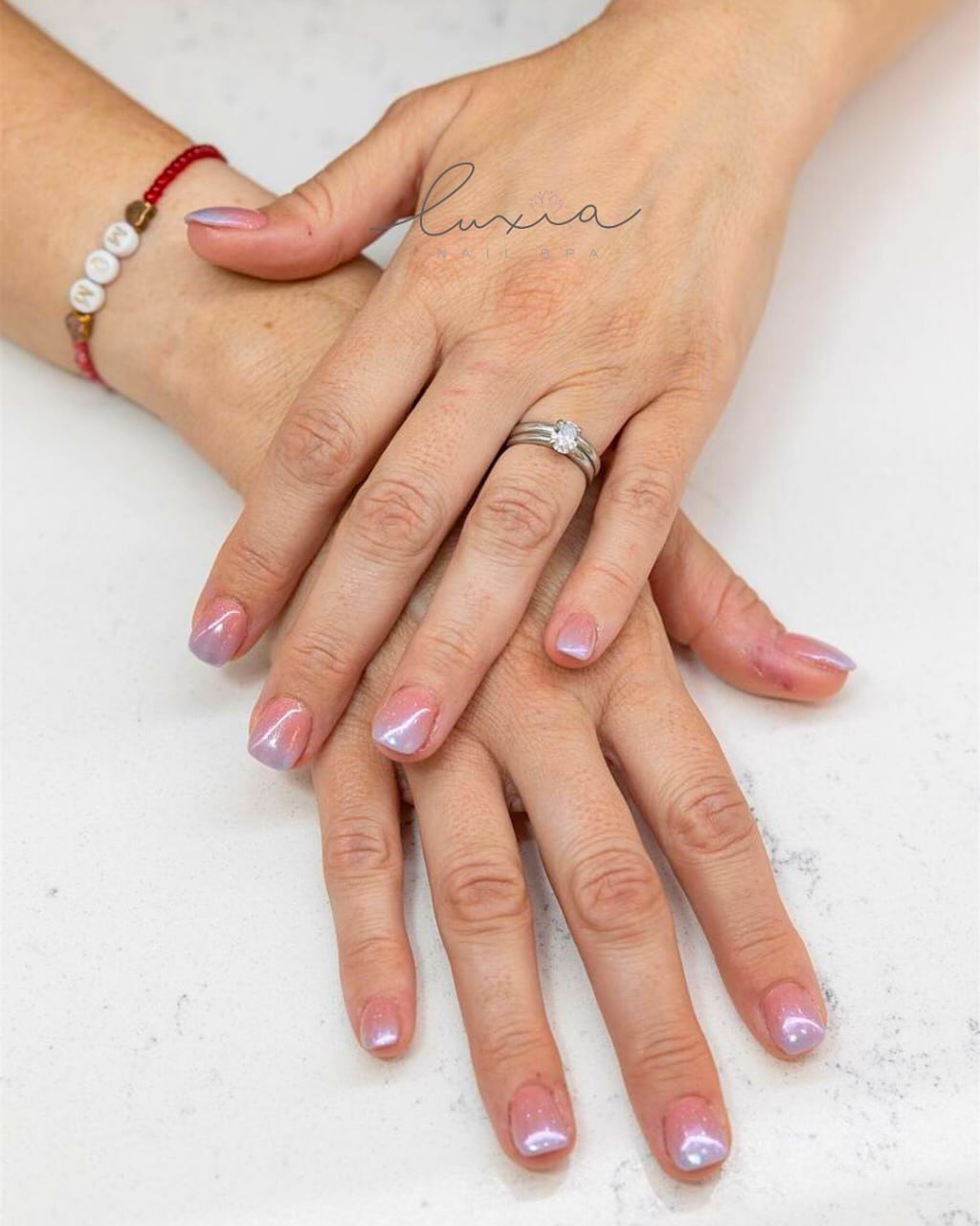 Soft pink and lavender shimmer ombre on short nails